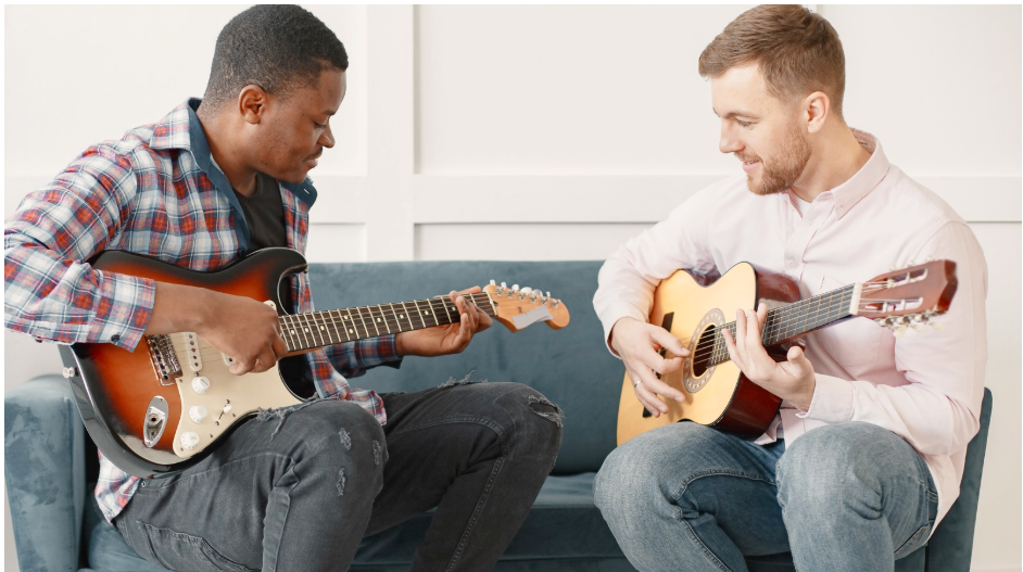 A teacher and a student with their guitars